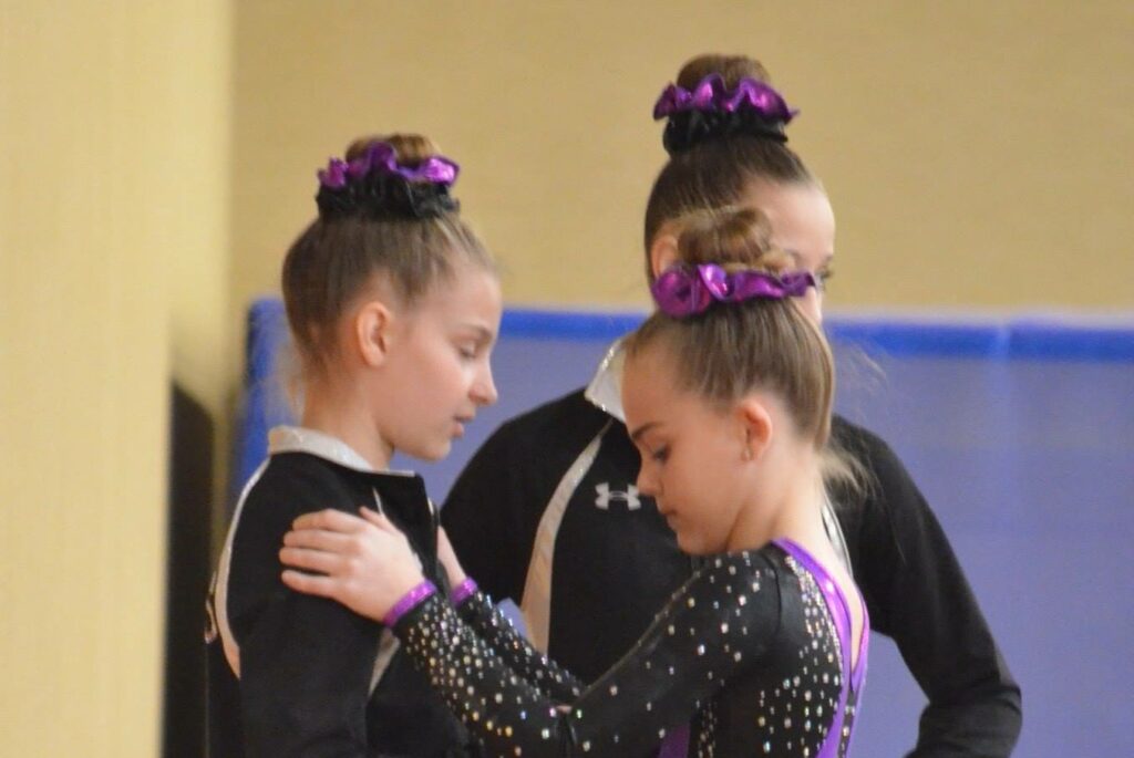 gymnasts encouraging each other at meet