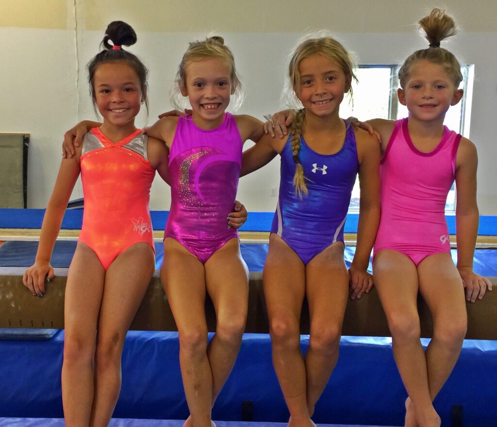 4 gymnasts sitting on bench